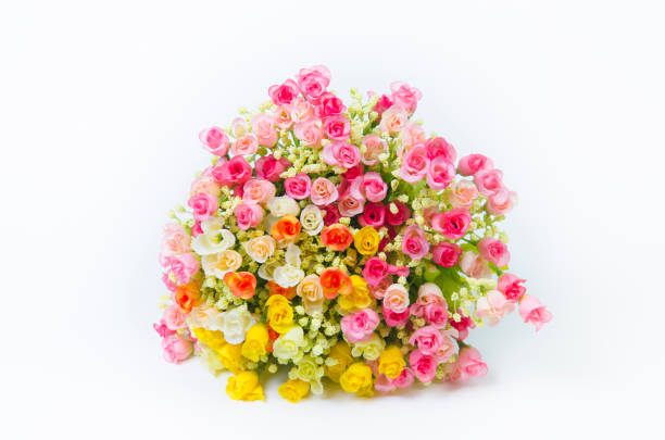 This beautiful flower decoration was placed outside a flower shop (or florist). All types of flowers, including rose, lily, aster, carnation, chrysanthemum, calla, anemone, anthurium, dahlia, delphinium, gerber, orchid, daffodil and peony were present, in delicate bouquets, in a plethora of colors including, red, pink, yellow, orange, white, blue and purple. Most of the flowers are artificial .