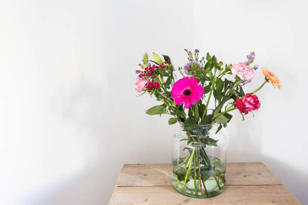 istock Colorful flowers in vase, summer decoration white wall 930252504