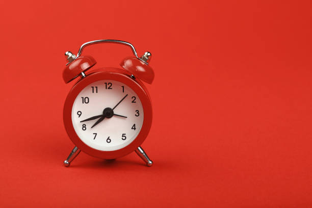 istock Close-Up Of Clock Against Red Background 930256992