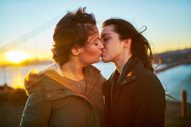 istock romantic lesbian couple kissing at golden gate bridge 930264752