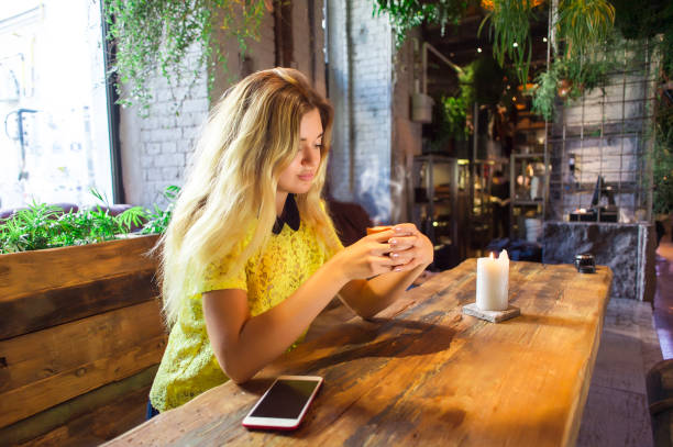 istock Beautiful girl with cup coffee sits in a cafe 930265230