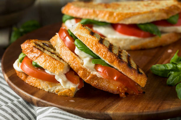 Healthy Grilled Basil Mozzarella Caprese Panini Healthy Grilled Basil Mozzarella Caprese Panini Sandwich sandwich stock pictures, royalty-free photos & images