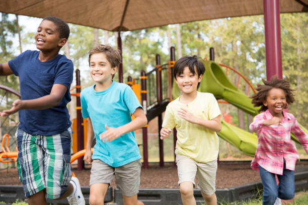 istock Multi-ethnic group of school children running on school playground. 930273558