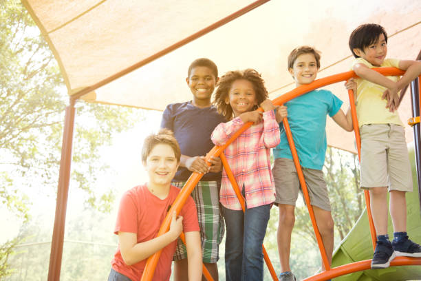 istock Multi-ethnic group of school children playing on school playground. 930273584