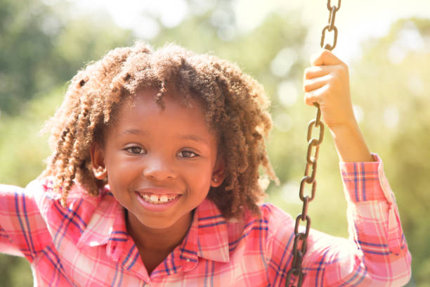 istock African descent school girl playing on school playground. 930273636
