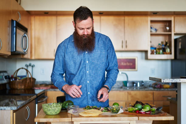 istock man making tacos at home in the kitchen 930273746