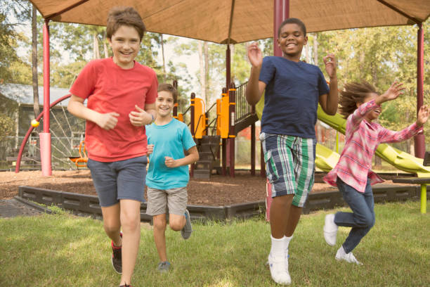 istock Multi-ethnic group of school children running on school playground. 930273772