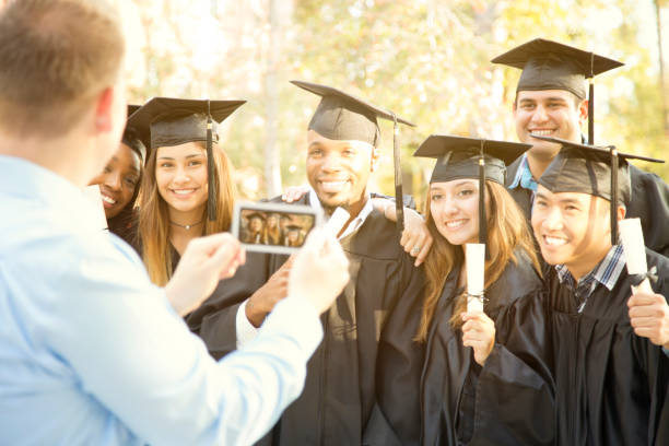 istock College students and father after graduation ceremony. 930273912