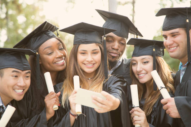 istock College student friends take selfie after graduation ceremony. 930277960