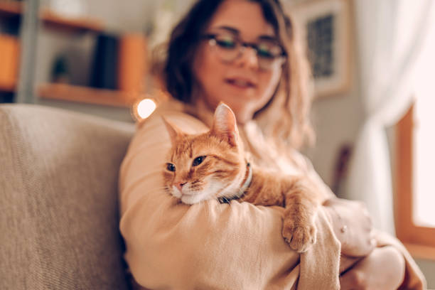 istock Young woman holding cat 930287390