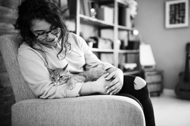 Young woman holding cat