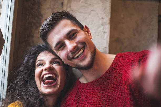 istock Young millennial couple taking selfie and making funny faces 930287704