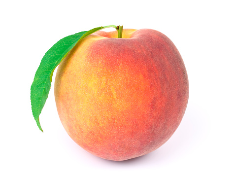Fresh peach with green leaf on white background