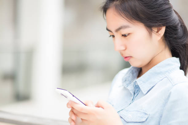 istock Young girl operating mobile phone 930301826