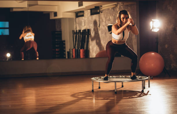 istock Woman exercising on a mini-trampoline at the gym 930308556