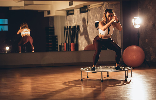 Woman exercising on a mini-trampoline at the gym