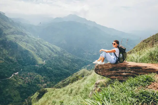 Tourist woman enjoy with beautiful view on mountains and valley in Ella, Sri Lanka, Little Adam Peak
