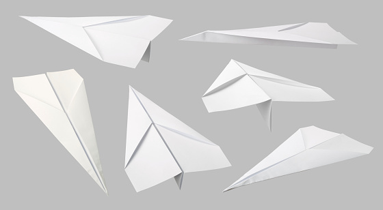 Toy paper plane on white background