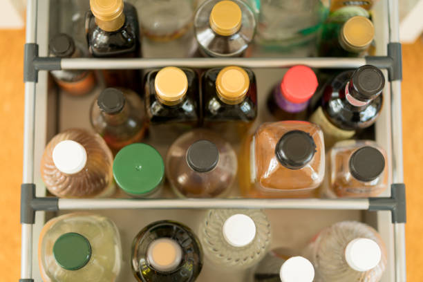 High angle view of a domestic kitchen drawer of sauces and cooking oils