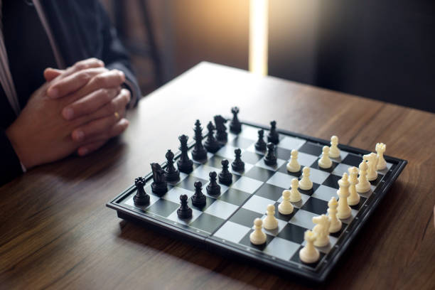 istock Businessman thinking how to play chess concept business strategy 930336564