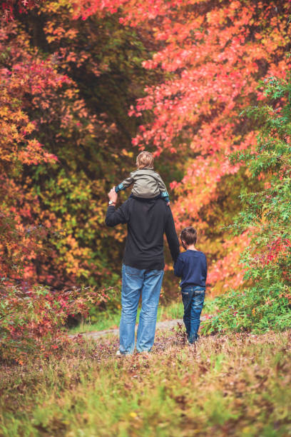 istock Father walking with kids 930346658