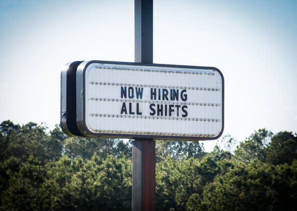 "Now Hiring All Shifts"  Sign A business openly advertises work opportunities. help wanted sign stock pictures, royalty-free photos & images