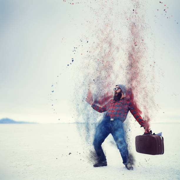 istock hipster with beard and suitcase turning into dust on the salt flats 930371312
