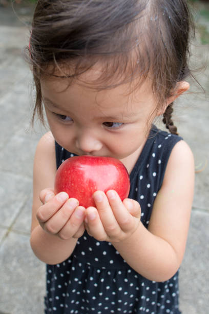 istock Little girl with apple 930371550