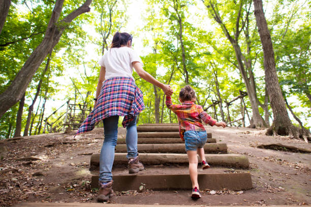 mère et fille marche dans la forêt. - family walking child park photos et images de collection
