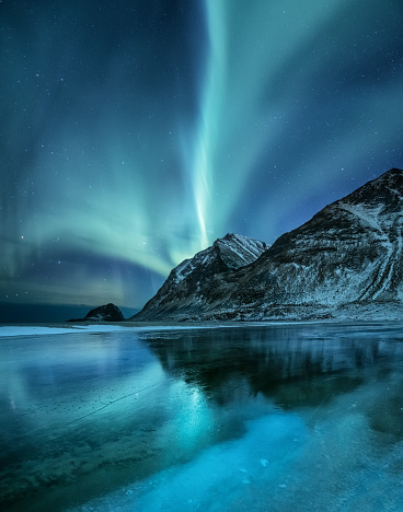 Northen light under mountains. Beautiful natural landscape in the Norway