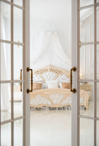 istock Open door leading to white classic bedroom 930396838