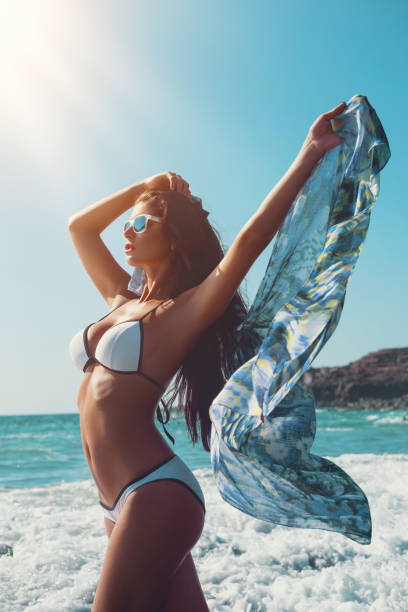 istock beautiful girl on beach 930406338