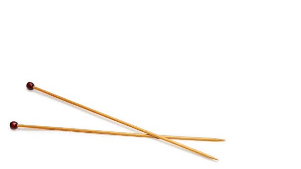 istock wooden knitting needles, lie crossed. Isolated on white background. copy space, template. 930406388