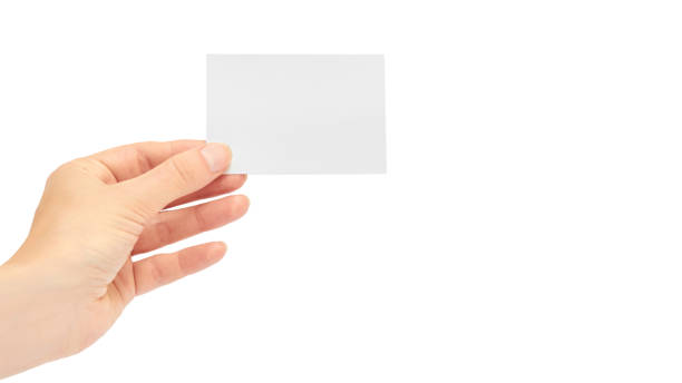 istock Female hands hold a business card. Isolated on white background. copy space, template 930406598