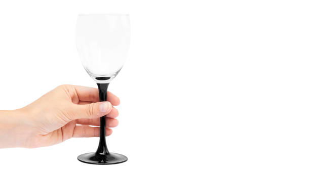 istock female hand holding empty wine glass. Isolated on white background. copy space, template 930406672