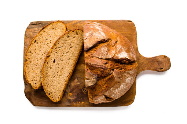 istock Loaf of rustic german bread on wooden board, isolated on white 930410148