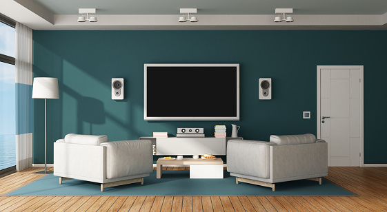 Blue and white living room with home cinema system - 3d rendering
