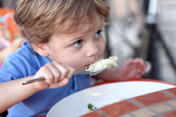 istock Child eating vareniki 930417220