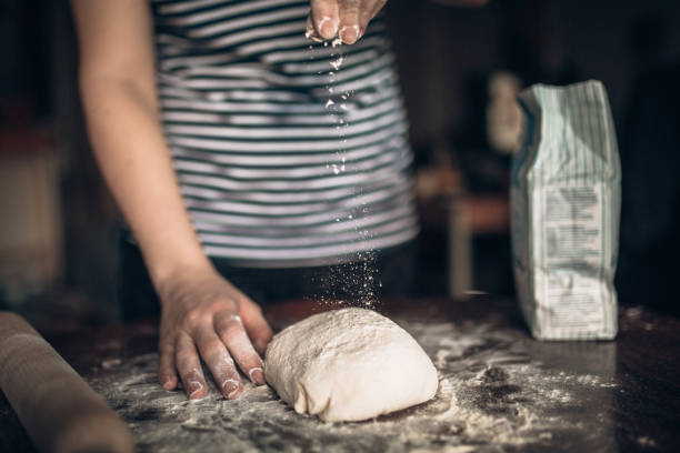 istock Hands baking dough with rolling pin on wooden table 930428592