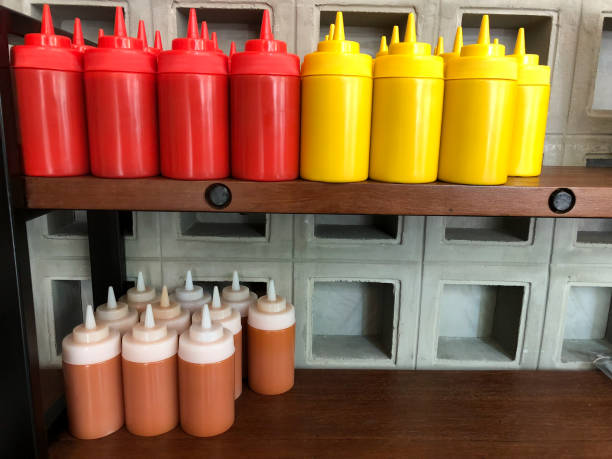 istock Mustard, ketchup and mayo sauces on wood shelf at restaurant 930431932