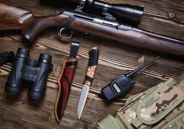 istock Hunting rifle and ammunition on a wooden background. 930433404