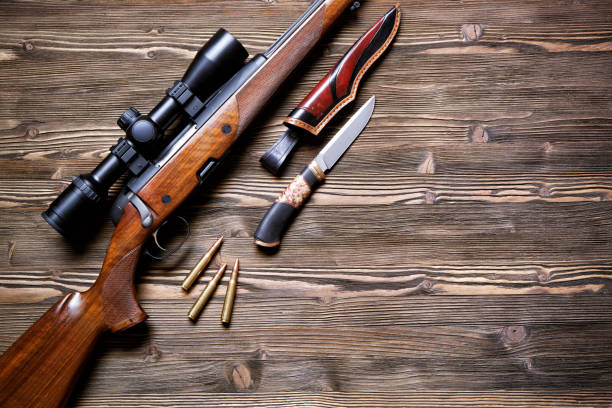 istock Hunting equipment on old wooden background. 930433426