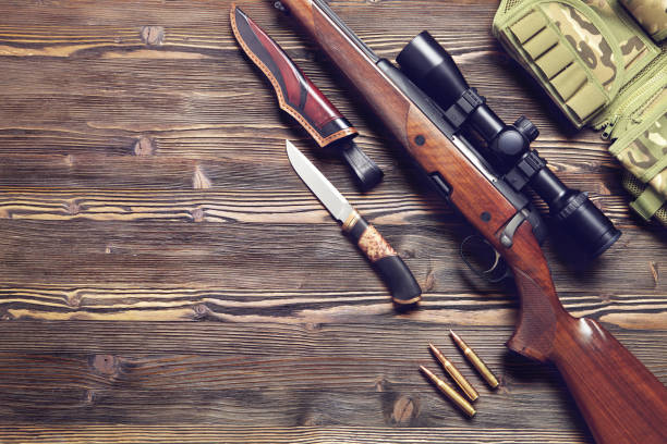 istock Hunting equipment on old wooden background. 930433436