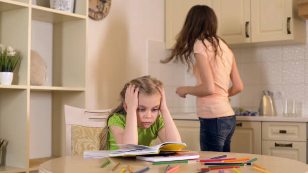 istock Woman is engaged in domestic duties while her daughter doing boring homework 930437028