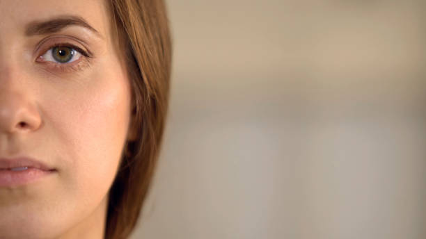 istock Young female half face looking into camera, average woman opinion statistics 930439680