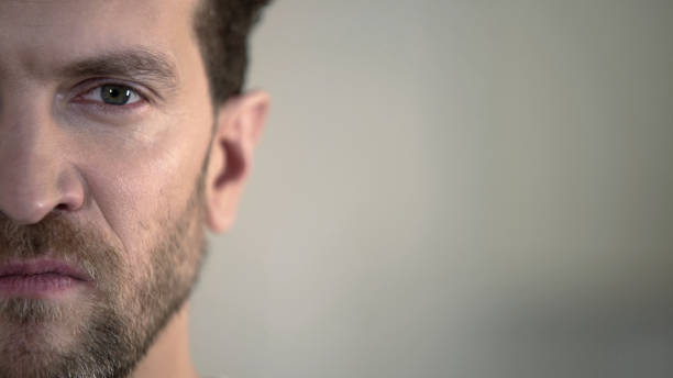 istock Half face of aggressive man looking with hatred into camera, domestic tyrant 930439802