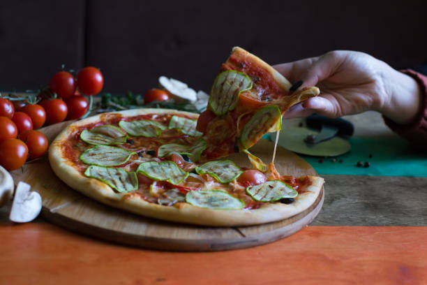 istock Girl eating vegetarian pizza at a cafe 930440536