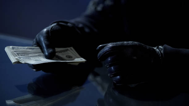 istock Criminal counting ransom money for kidnapping, blackmail, contract killing 930441232