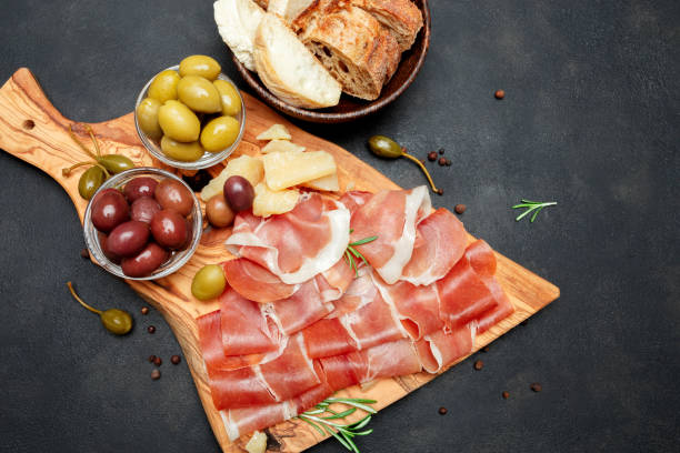 istock Italian prosciutto crudo or spanish jamon. Raw ham on white background. 930441244
