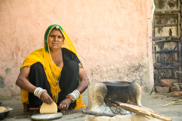 istock Rural Indian woman rolling dough 930445400